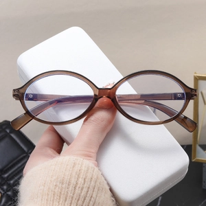 Detail of oval tea-colored transparent eyeglasses frame with a white textured case