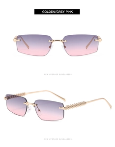 Detail of frameless sunglasses with golden metal temples and grey pink gradient lenses