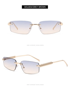 Close-up of rimless polygon sunglasses with golden rivet temples and gradient blue lenses