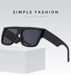 Detail of square oversized sunglasses with silver rivet accents and thick temples