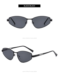 Detail of black metal cat eye sunglasses with geometric cut-out frame and dark grey lenses