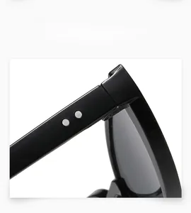 Detail of vintage sunglasses frame with silver rivet hinges on sleek black temples