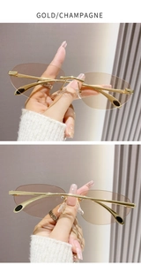 Détail de lunettes de soleil sans monture en métal doré avec verres ovales champagne