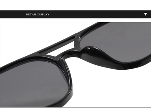 Vue macro de lunettes de soleil noires à double pont montrant les plaquettes et le cadre