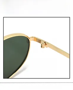 Detail view of the durable gold metal hinge and sleek arm on vintage cat-eye sunglasses