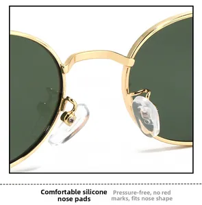 Detail of adjustable silicone nose pads on gold metal sunglasses for comfort and fit