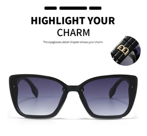 Detail of square oversized sunglasses showing golden letter B metal hinge and gradient lenses
