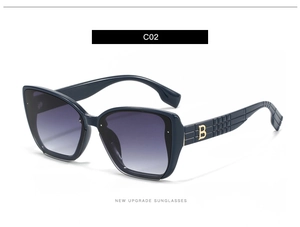 Detailed view of luxury sunglasses featuring golden B logo and textured temple design