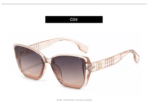 Detail showing gold B logo and check texture on champagne frame sunglasses arms