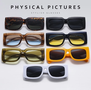 Collection of stylish rectangular sunglasses in various colors on a grey gradient background
