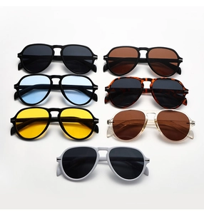 Flat lay of seven oversized aviator sunglasses in various colors and leopard patterns