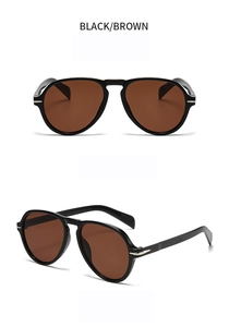 Close-up of oversized aviator sunglasses with black frames and brown tinted lenses