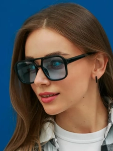 Side view of model wearing vintage black square sunglasses with light blue lenses
