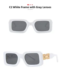 Detail view of white square sunglasses with gold chain-link metal trim and gray lenses