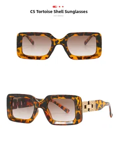 Detail of tortoiseshell rectangle sunglasses with golden metal link decor and gradient lenses
