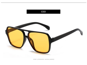Detail view of double bridge aviator sunglasses with yellow lenses and black frame