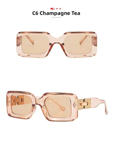 Detail of champagne tea rectangle sunglasses featuring textured gold metal temple hinges