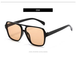 Close-up of retro double-bridge square sunglasses with bright black frames and orange lenses