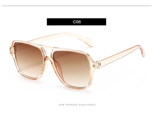 Detail view of square pilot sunglasses with transparent champagne frames and brown lenses