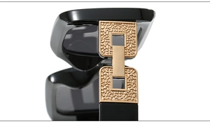 Close-up of black sunglasses with luxury textured gold metal chain detail on the temple