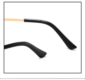 Detail of gold metal glasses temple with ergonomic black plastic ear tip and sleek hinge
