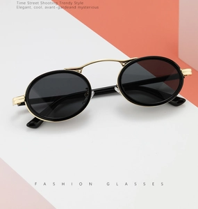 Detail of vintage steampunk oval sunglasses with gold metal frame and black lenses