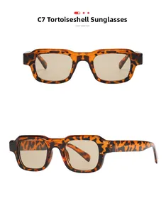Macro detail of tortoiseshell square sunglasses with thick frames and brown tinted lenses