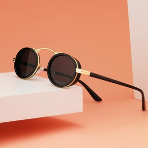 Steampunk retro oval sunglasses with matte black frames and golden metal details