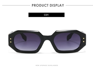 Detail view of black geometric sunglasses frame with gold rivets and purple gradient lens