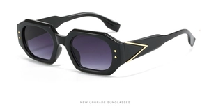 Detailed close-up of geometric black frame sunglasses with golden V-shaped metal accents
