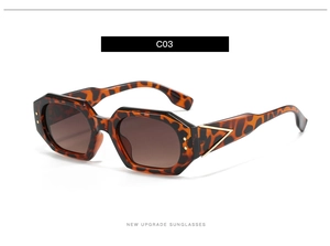 Detail of tortoise shell polygon sunglasses with gold V-metal logo on the temple arm