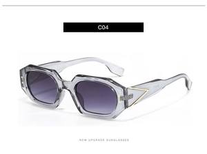 Detail view of translucent grey geometric sunglasses with golden triangle temple accents