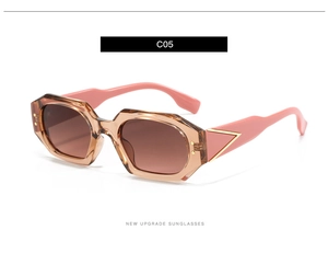 Detail of polygonal sunglasses with translucent frame and gold triangle metal hinge accent