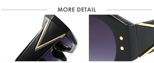 Close-up of black polygon frames featuring gold V-shaped temple accents and round rivets