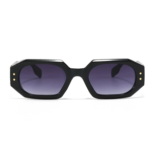 Polygonal black sunglasses with purple gradient lenses and gold rivet accents on frame