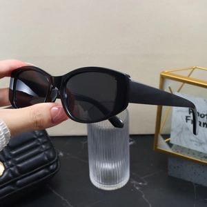 Detailed close-up of premium black square cat-eye sunglasses on a marble tabletop