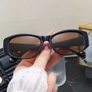 Close-up of retro rectangular chunky frame sunglasses with translucent tinted lenses