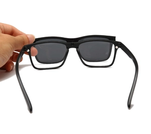 Detail of hand snapping a black magnetic polarized lens onto the TR90 eyeglass frame