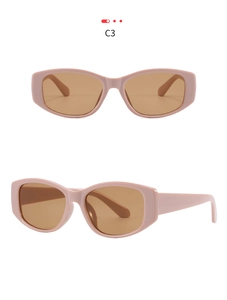 Detail view of retro oval cat eye sunglasses with pink frame and tinted brown lenses