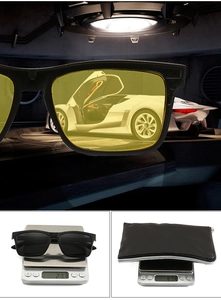 Detail view of yellow night vision glasses showing light weight and protective zipper case