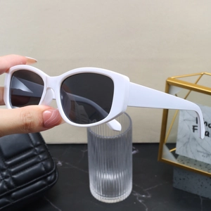 Retro white square cat-eye sunglasses with dark lenses held in a stylish setting