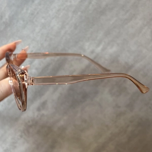 Detailansicht der transparenten hellrosa Cateye-Sonnenbrille mit Bügel-Schriftzug