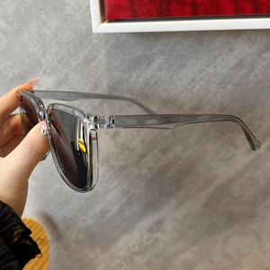 Macro detail of inner temple arm on square gray sunglasses showing model numbers