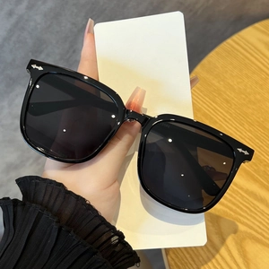 Classic oversized black square sunglasses with silver arrow accents for a slim face look
