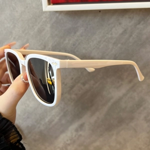 Detail of white thick frame sunglasses with iconic silver arrow metal hinge design