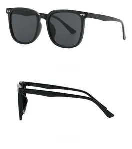 Detail shot of black square frame sunglasses with silver arrow rivets and dark lenses