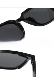 Detailed macro view of black glossy frame with integrated nose pads and metal hinges
