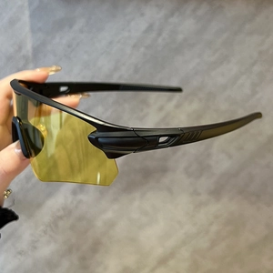 Détail de lunettes de sport noires avec verres teintés jaunes pour une vision optimale