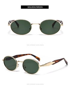 Détail de lunettes de soleil ovales avec monture dorée, verres verts et branches en écaille