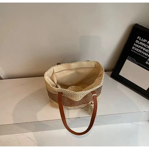 Top view of two-tone woven tote showing interior zipper pocket and cream lining